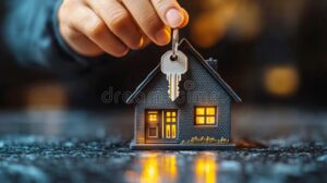 manos sosteniendo llaves y casa pequena